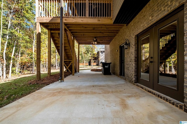 view of patio / terrace featuring ceiling fan, a deck, and french doors