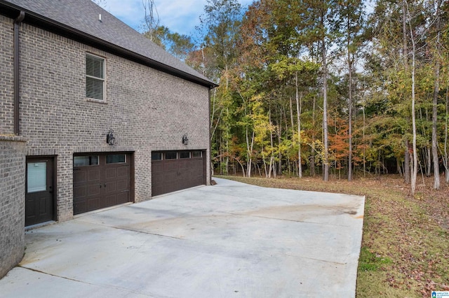 view of side of home featuring a garage