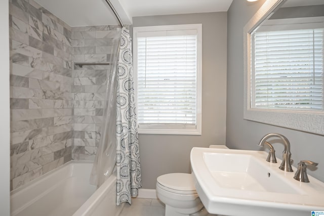 full bathroom featuring plenty of natural light, shower / bath combo, and toilet