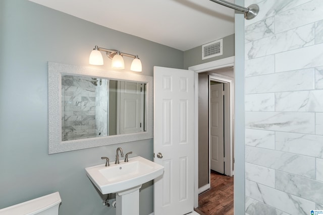 bathroom featuring hardwood / wood-style floors, sink, and toilet