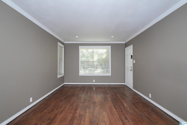 empty room featuring dark hardwood / wood-style floors and ornamental molding