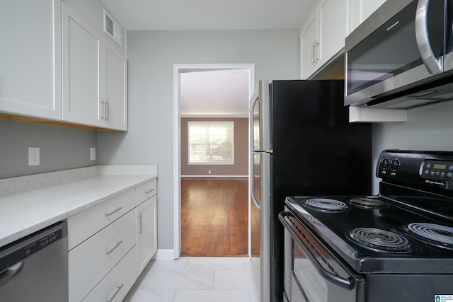 kitchen featuring white cabinets, light hardwood / wood-style floors, and stainless steel appliances