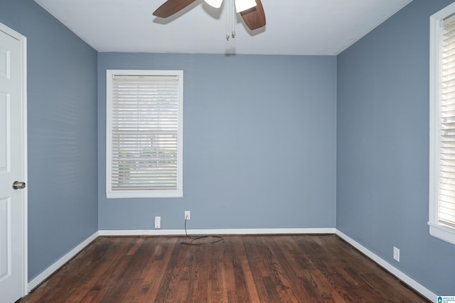 spare room with dark hardwood / wood-style flooring and ceiling fan