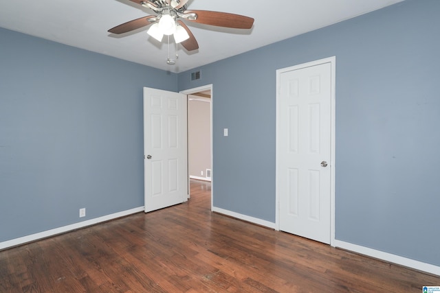 unfurnished bedroom featuring dark hardwood / wood-style flooring and ceiling fan