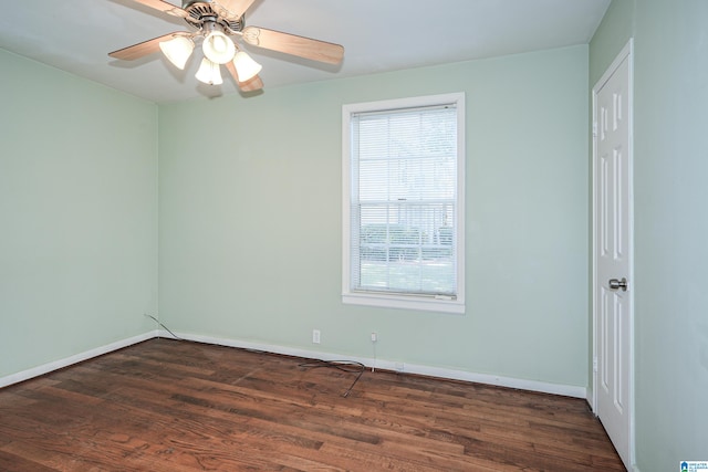 empty room featuring ceiling fan and dark hardwood / wood-style floors