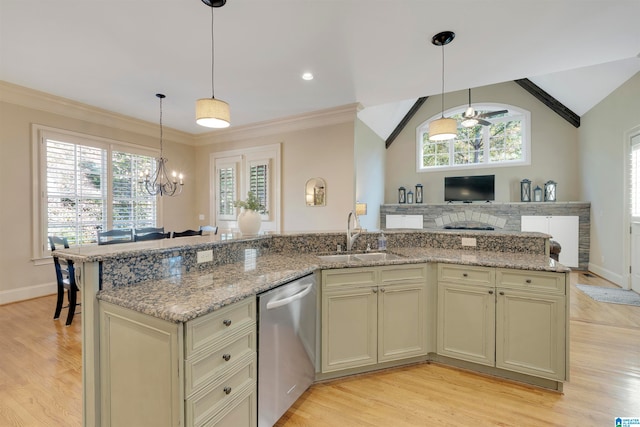 kitchen featuring dishwasher, cream cabinets, sink, and a healthy amount of sunlight