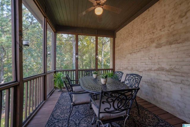 unfurnished sunroom with ceiling fan and wood ceiling