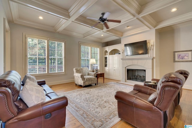 living room featuring ceiling fan, beamed ceiling, light wood-type flooring, and coffered ceiling