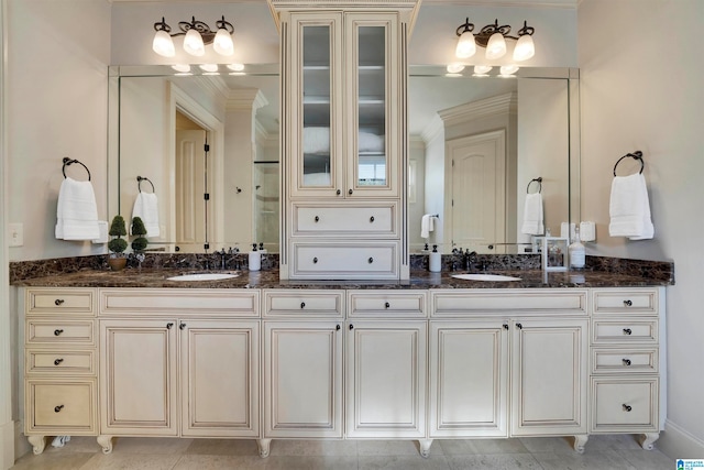 bathroom with ornamental molding and vanity