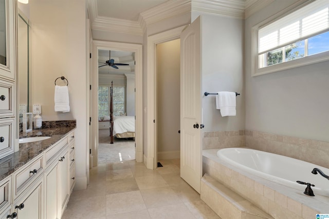 bathroom featuring tiled tub, plenty of natural light, ornamental molding, and vanity