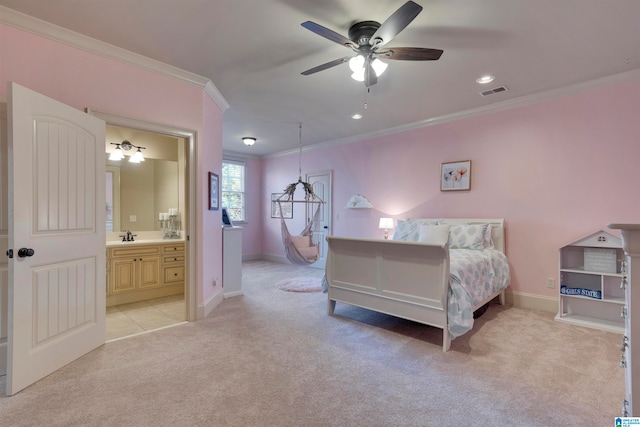 bedroom featuring ceiling fan, light colored carpet, crown molding, and connected bathroom