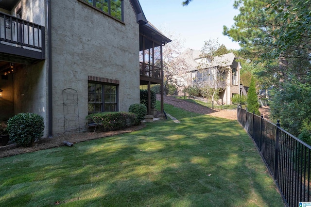 view of yard featuring a balcony