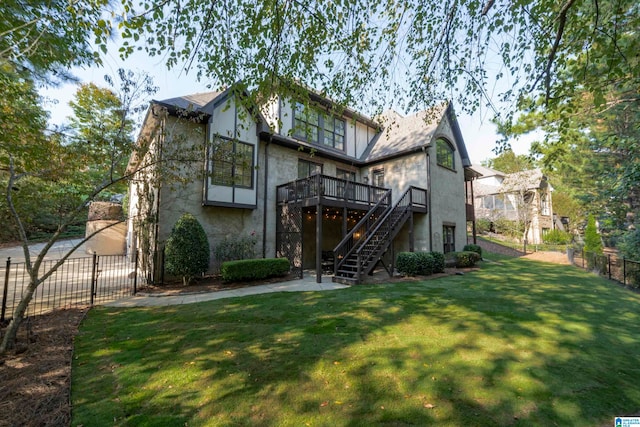 back of house featuring a deck and a yard