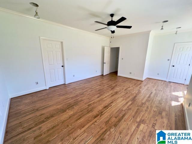 empty room featuring crown molding, hardwood / wood-style flooring, and ceiling fan