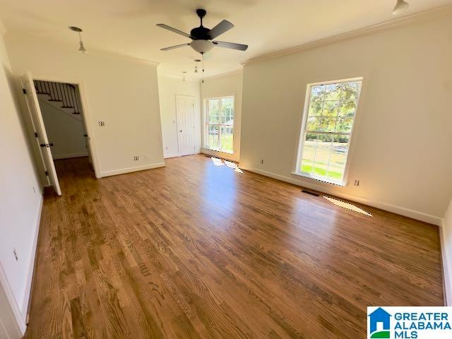 spare room featuring crown molding, hardwood / wood-style flooring, and ceiling fan