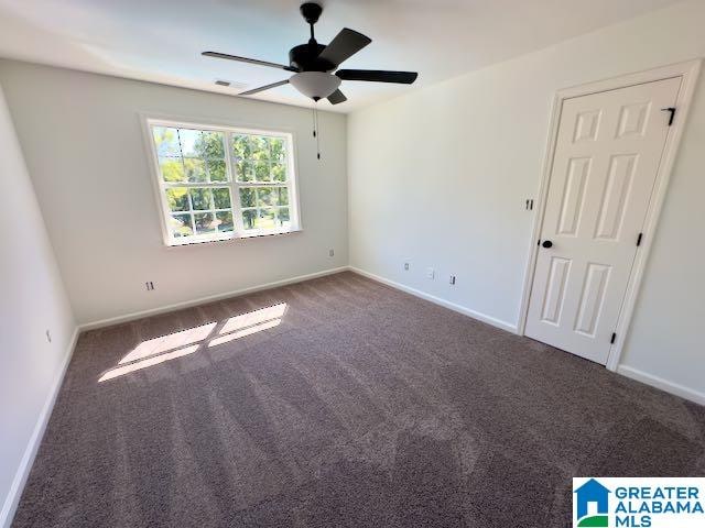 carpeted empty room featuring ceiling fan