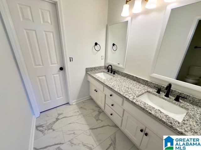 bathroom featuring toilet and vanity