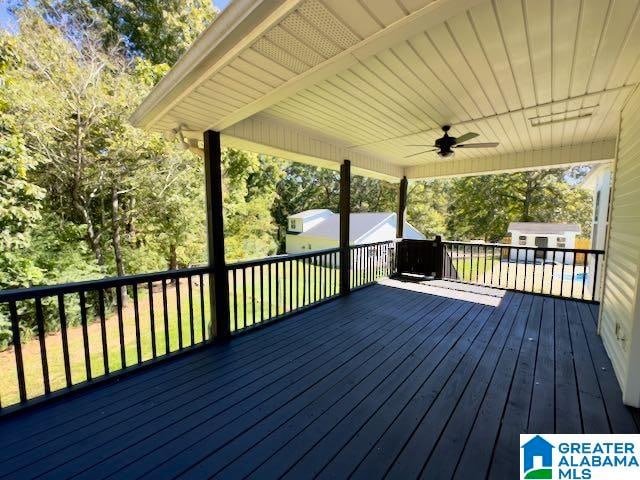 wooden terrace featuring ceiling fan