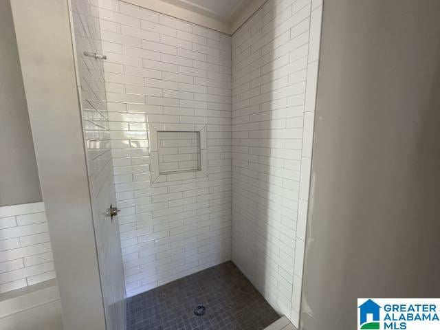 bathroom with tiled shower