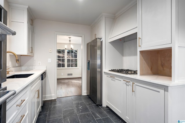 kitchen featuring white cabinets, stainless steel appliances, and a sink