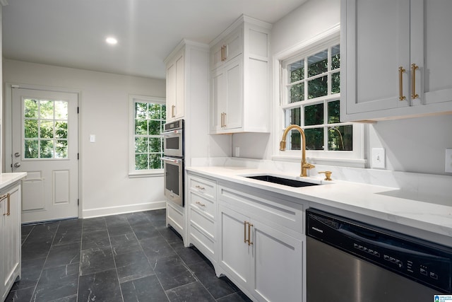 177 Ross Dr, Mountain Brook, AL 35213 - kitchen with appliances with stainless steel finishes, a sink, white cabinetry, baseboards, and light stone countertops
