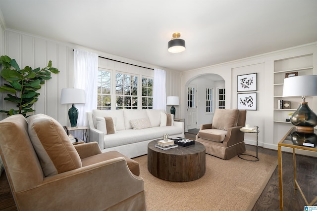 177 Ross Dr, Mountain Brook, AL 35213 - living area with arched walkways, wood finished floors, built in shelves, and baseboards