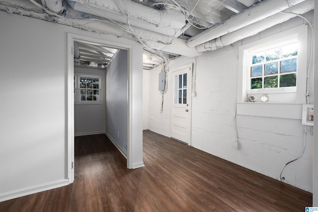 basement featuring dark wood-style floors and electric panel