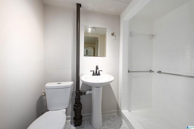 bathroom with toilet and baseboards