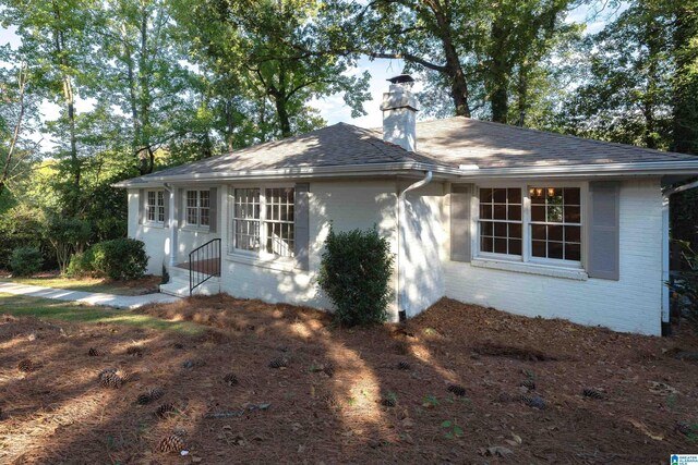 177 Ross Dr, Mountain Brook, AL 35213 - back of property with brick siding, a chimney, and a shingled roof