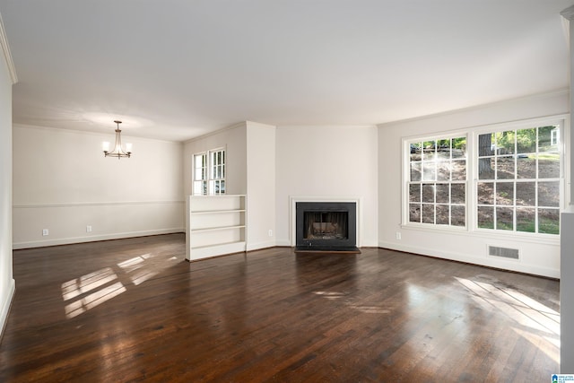 unfurnished living room featuring crown molding, dark wood-style flooring, visible vents, and a fireplace