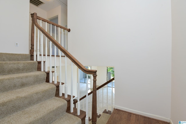 staircase featuring wood-type flooring