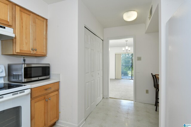 181 Cambrian Way Unit 181, Birmingham, AL 35242 - kitchen featuring white electric range, stainless steel microwave, a chandelier, light countertops, and light flooring