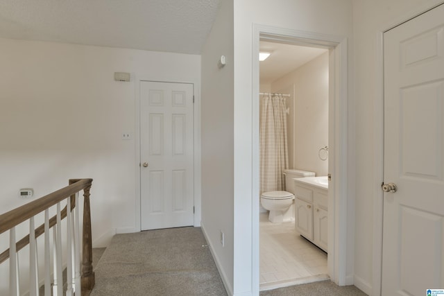 bathroom featuring curtained shower, a textured ceiling, toilet, tile patterned floors, and vanity