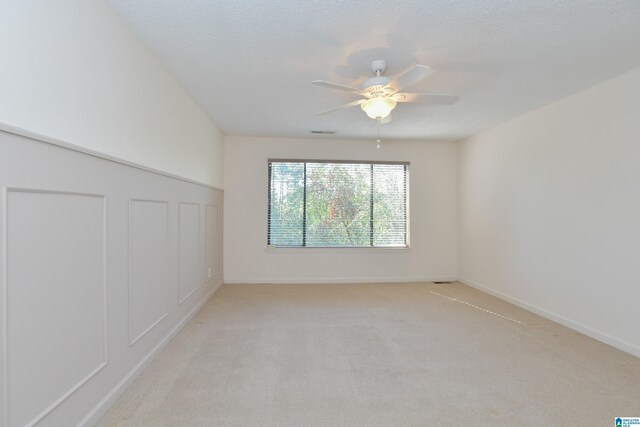 181 Cambrian Way Unit 181, Birmingham, AL 35242 - unfurnished room featuring a ceiling fan, light carpet, a decorative wall, and a wainscoted wall