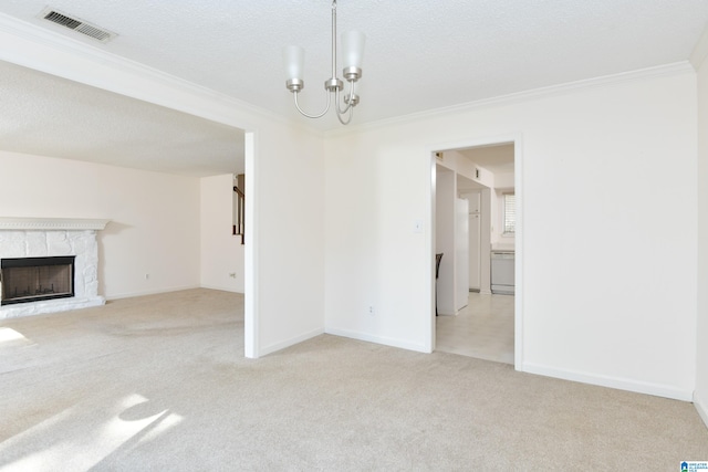 interior space with crown molding, a premium fireplace, a textured ceiling, and light colored carpet