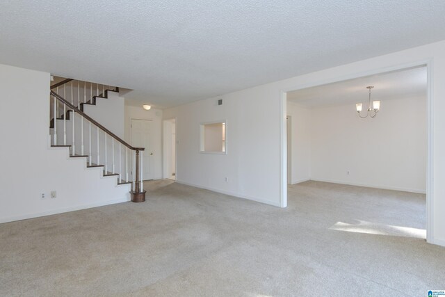 181 Cambrian Way Unit 181, Birmingham, AL 35242 - unfurnished living room with carpet, a chandelier, stairs, baseboards, and a textured ceiling
