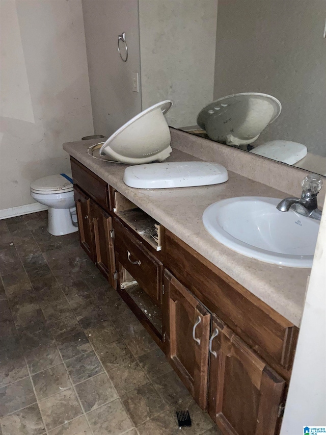 bathroom featuring vanity and toilet