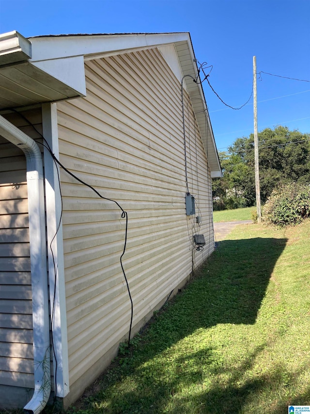 view of side of property with a yard