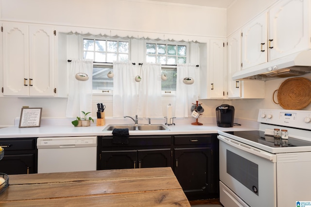 kitchen with white appliances, white cabinetry, and sink