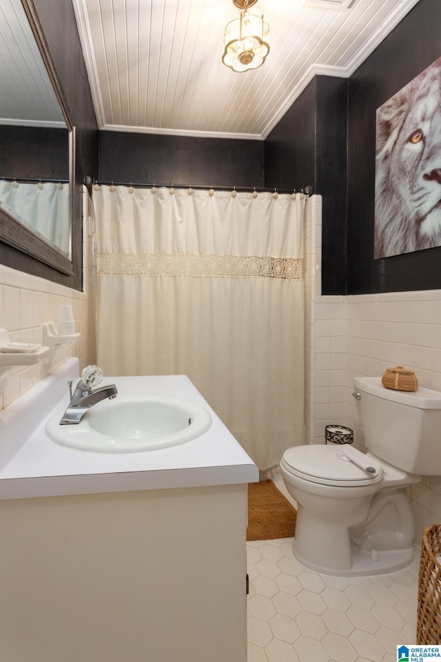 bathroom featuring ornamental molding, vanity, tile walls, tile patterned flooring, and toilet