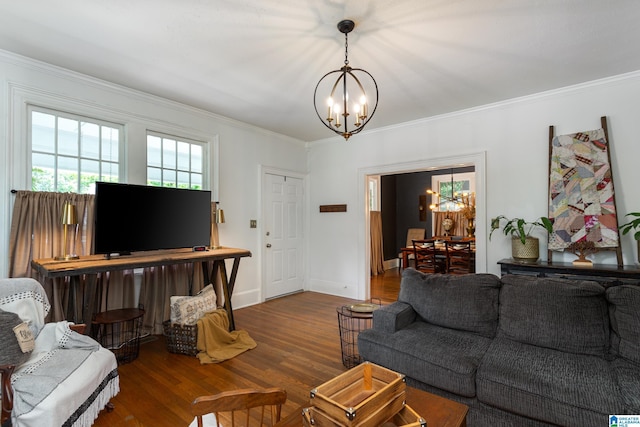 living room featuring dark hardwood / wood-style flooring, ornamental molding, and a chandelier