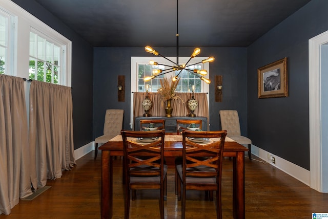 dining space featuring dark hardwood / wood-style flooring and a notable chandelier