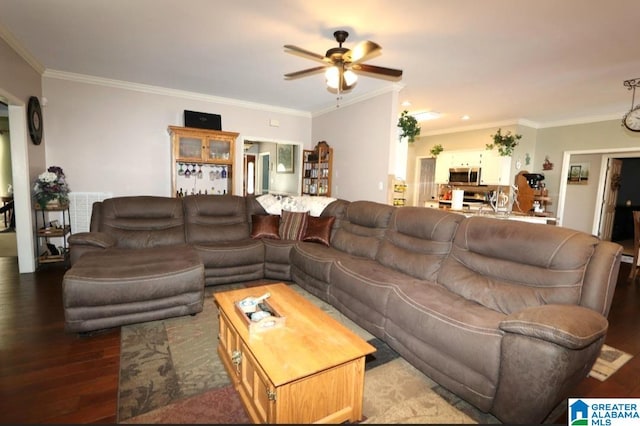 living room with hardwood / wood-style flooring, ceiling fan, and crown molding