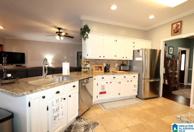 kitchen with white cabinets, kitchen peninsula, and appliances with stainless steel finishes