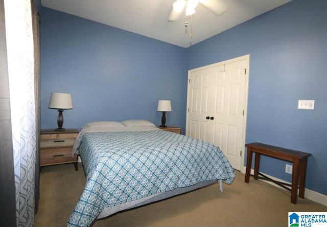 bedroom featuring ceiling fan, a closet, and carpet floors