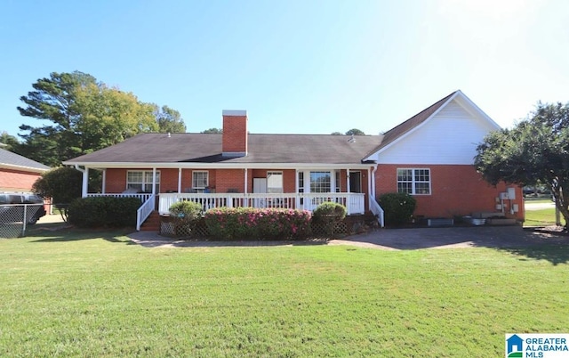 ranch-style house with a front yard and covered porch