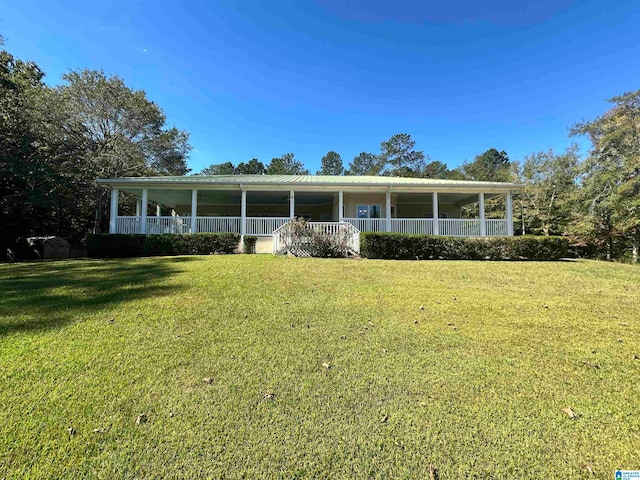 view of front of home featuring covered porch and a front lawn