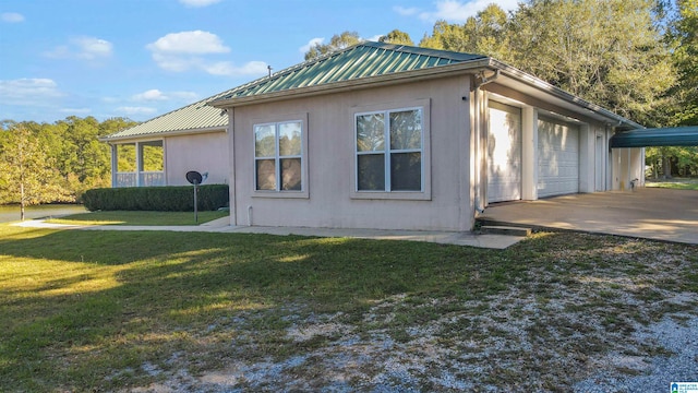 view of home's exterior with a yard and a garage