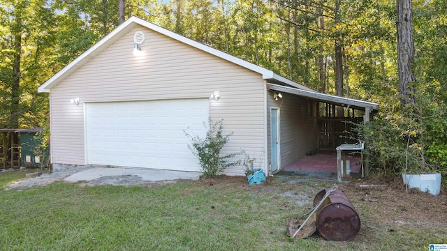 garage with a yard and wood walls