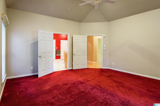 unfurnished bedroom featuring ceiling fan, lofted ceiling, and light colored carpet